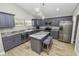 Modern kitchen with gray cabinets, granite counters and island at 748 Mcclellan Rd, Frostproof, FL 33843