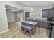 Modern kitchen with gray cabinets, granite counters and island at 748 Mcclellan Rd, Frostproof, FL 33843