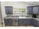 Modern kitchen with gray cabinets, granite countertops, and a sink at 748 Mcclellan Rd, Frostproof, FL 33843