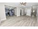 Open concept living room with kitchen view and wood-look floors at 748 Mcclellan Rd, Frostproof, FL 33843