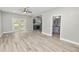 Spacious living room with wood-look floors and french doors at 748 Mcclellan Rd, Frostproof, FL 33843