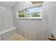 Large walk-in shower with a built-in bench and window at 748 Mcclellan Rd, Frostproof, FL 33843