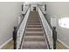 Elegant staircase with dark wood railings and carpeted steps at 748 Mcclellan Rd, Frostproof, FL 33843