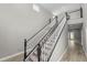 Grand staircase with dark wood and white spindles at 748 Mcclellan Rd, Frostproof, FL 33843