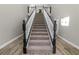 Grand staircase with dark wood and white spindles at 748 Mcclellan Rd, Frostproof, FL 33843