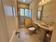 Bathroom with pedestal sink, toilet, and a shower with glass enclosure at 1015 Crossroads Dr, Polk City, FL 33868