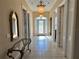Elegant entryway with tile flooring, glass front door, and a decorative light fixture at 1015 Crossroads Dr, Polk City, FL 33868