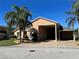 Attractive single-story residence with a large portico, side garage, and well-kept lawn at 1015 Crossroads Dr, Polk City, FL 33868
