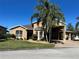 Charming single-story home with lush landscaping, large palm tree, and a spacious driveway at 1015 Crossroads Dr, Polk City, FL 33868