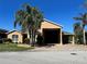 Inviting single-story home featuring a large portico, side garage, and manicured front yard at 1015 Crossroads Dr, Polk City, FL 33868