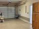 Attached garage with built-in cabinets and shelving at 1015 Crossroads Dr, Polk City, FL 33868