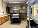 Garage with golf cart, storage cabinets and shelving at 1015 Crossroads Dr, Polk City, FL 33868