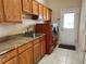 Laundry room with wood cabinets, granite countertop, and a convenient sink at 1015 Crossroads Dr, Polk City, FL 33868