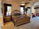 Spacious main bedroom with ornate bed and sitting area at 1015 Crossroads Dr, Polk City, FL 33868