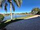 Brick patio overlooking a lake with fountain and golf course at 1015 Crossroads Dr, Polk City, FL 33868