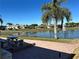 Lake view from backyard patio with fountain and golf course at 1015 Crossroads Dr, Polk City, FL 33868