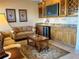 Home wet bar with wine storage and granite countertop at 1015 Crossroads Dr, Polk City, FL 33868