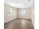 Bright bedroom with wood-look floors and two windows at 107 W 7Th St, Frostproof, FL 33843