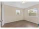 Simple bedroom with wood-look floors and two windows at 107 W 7Th St, Frostproof, FL 33843