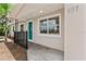 Welcoming front porch with teal door and black metal railing at 107 W 7Th St, Frostproof, FL 33843