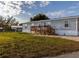 Single-wide mobile home with wood deck and steps at 1126 Lakewood W Cir, Lakeland, FL 33801
