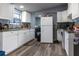 Full kitchen with white cabinets and laminate flooring at 1126 Lakewood W Cir, Lakeland, FL 33801