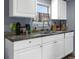 White cabinets, granite countertops, and kitchen appliances at 1126 Lakewood W Cir, Lakeland, FL 33801