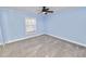 Bright bedroom with gray carpeting and ceiling fan at 2206 Golden Horseshoe N Cir, Lakeland, FL 33810