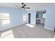 Spacious bedroom with light blue walls, ceiling fan, and plush carpeting at 2206 Golden Horseshoe N Cir, Lakeland, FL 33810