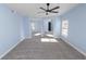Light blue bedroom with gray carpeting, ceiling fan and mirrored closet doors at 2206 Golden Horseshoe N Cir, Lakeland, FL 33810