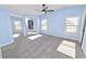 Light blue bedroom with gray carpeting, ceiling fan and mirrored closet doors at 2206 Golden Horseshoe N Cir, Lakeland, FL 33810