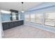 Bright dining room with light blue walls, gray cabinetry, and wood-look flooring at 2206 Golden Horseshoe N Cir, Lakeland, FL 33810