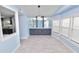 Bright dining room with light blue walls, gray cabinetry, and wood-look flooring at 2206 Golden Horseshoe N Cir, Lakeland, FL 33810