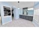 Bright dining room with light blue walls, gray cabinetry, and wood-look flooring at 2206 Golden Horseshoe N Cir, Lakeland, FL 33810