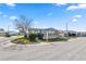 Mobile home on a corner lot with mature trees and manicured lawn at 2206 Golden Horseshoe N Cir, Lakeland, FL 33810