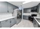 Modern kitchen with gray cabinets, stainless steel appliances, and white subway tile backsplash at 2206 Golden Horseshoe N Cir, Lakeland, FL 33810