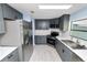 Modern kitchen with gray cabinets, stainless steel appliances, and white subway tile backsplash at 2206 Golden Horseshoe N Cir, Lakeland, FL 33810