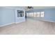 Spacious living room with light blue walls, ceiling fan, and wood-look flooring at 2206 Golden Horseshoe N Cir, Lakeland, FL 33810