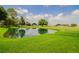 Serene pond with lush green landscaping at 2206 Golden Horseshoe N Cir, Lakeland, FL 33810