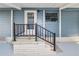 Side entrance with stairs and a black metal railing leading to the home at 2206 Golden Horseshoe N Cir, Lakeland, FL 33810