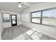 Sunroom features gray carpeting, ceiling fan, and multiple windows at 2206 Golden Horseshoe N Cir, Lakeland, FL 33810