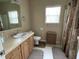 Functional bathroom with vanity, toilet, and shower with curtain, offering practicality and neutral tones at 2356 Peavine Cir # 1017, Lakeland, FL 33810