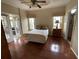 Main bedroom featuring hardwood floors, a ceiling fan, and French doors leading to the Florida room at 2356 Peavine Cir # 1017, Lakeland, FL 33810