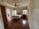 Bedroom with ceiling fan, hardwood flooring, and adjoining Florida room enhances the space at 2356 Peavine Cir # 1017, Lakeland, FL 33810