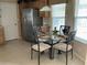Eat-in kitchen features a stainless refrigerator and a glass table with 4 chairs at 2356 Peavine Cir # 1017, Lakeland, FL 33810