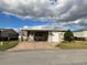 Tan single-story home with carport and landscaping at 2356 Peavine Cir # 1017, Lakeland, FL 33810