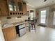 Inviting kitchen area featuring a sink, beverage cooler, and cozy breakfast nook with a view to the lanai at 2356 Peavine Cir # 1017, Lakeland, FL 33810