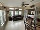 Bright living room with large windows, tile floors and comfortable seating leading into the adjacent bedroom at 2356 Peavine Cir # 1017, Lakeland, FL 33810