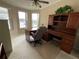 Bright office space with built-in desk and shelving with natural light from the windows at 2356 Peavine Cir # 1017, Lakeland, FL 33810