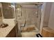 A tiled shower with glass doors, towel rack, a showerhead, and a wooden waste bin at 2356 Peavine Cir # 1017, Lakeland, FL 33810